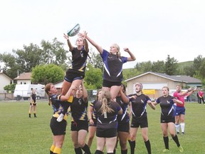 Hawk Jordan Tharle is lifted by teammates Teri McIntyre, front, and Rhiann Nerwal, behind, during provincials, which took place last Friday and Saturday in Black Diamond. Steve Sucha Postmedia Network