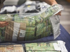 The Combined Forces Special Enforcement Unit British Columbia announced the dismantling of an illegal gambling and money laundering ring at RCMP HQ in Surrey, BC Tuesday, June 13, 2017. Pictured is money seized as evidence during the investigation. (Photo by Jason Payne/ PNG)