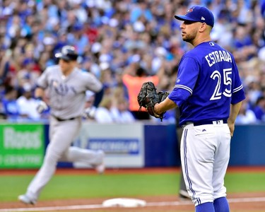 Toronto Blue Jays starting pitcher Marco Estrada (25) reacts as Tampa Bay Rays first baseman Logan Morrison (7) rounds the bases on a three-run home run during third inning American League baseball action in Toronto, Tuesday, June 13, 2017. THE CANADIAN PRESS/Frank Gunn ORG XMIT: FNG522