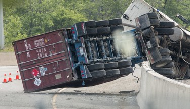 A rolled over transport truck caused major traffic headaches after both directions of the QEW highway were closed down Tuesday June 13 2017 just west of Martindale Rd. in St. Catharines.  Police evacuated a large area due to a potential hazardous gas the transport was carrying.  Bob Tymczyszyn/St. Catharines Standard/Postmedia Network
