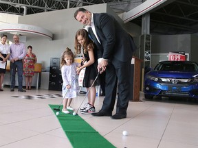 Vince Palladino, president of Palladino Auto Group, along with his daughter Ella, and Stella Carrier, putt at a press conference kicking off the Palladino Auto Group Golf Classic for NEO Kids in Sudbury, Ont. on Tuesday June 13, 2017. Gino Donato/Sudbury Star/Postmedia Network