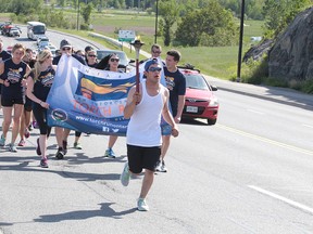 Participants from Special Olympics Ontario, members of the Greater Sudbury Police Service and community supporters participate in the 30th annual Greater Sudbury Law Enforcement Torch Run in Sudbury on Tuesday. Gino Donato/Sudbury Star/Postmedia Network