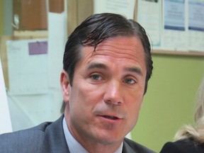 In this June 5, 2017 photo, Nick Lyon, Michigan Health and Human Services Director, speaks in support of the state's Medicaid expansion program in Lansing, Mich. Lyon was charged Wednesday, June 14, 2017, with involuntary manslaughter in a criminal investigation of Flint's lead-contaminated water. (AP Photo/David Eggert)
