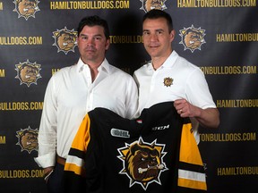 Dave Matsos, left, poses for a photo alongside Hamilton Bulldogs president and general manager Steve Staios during a press conference to introduce Matsos as Hamilton's new associate coach. Photo supplied