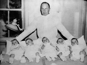 Depression-era premier Mitch Hepburn of St. Thomas poses with the world-famed Dionne quintuplets, babies his government made wards of the state. (Library and Archives Canada)