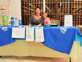 Relay for Life committee member Jessica McClelland and her daughter Sarah set up a table in Ranchland mall on June 9 to sell luminaries and other merchandise for the upcoming walk in Pincher Creek which takes place on June 24.