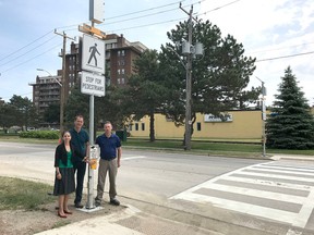 Kristina Zimmer, left, and Randy Provencal of the Shell Manufacturing Centre in Corunna, and the City of Sarnia's Mike Berkvens, stand at a new Front Street pedestrian crossover. Shell has donated $40,000 towards a project that improves access to Centennial Park. (Submitted)