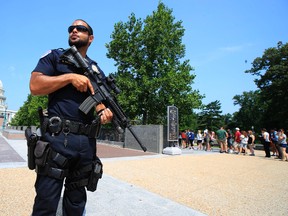 Capitol Hill Police officer Nathan Rainey stands guard on Capitol Hill in Washington, Wednesday, June 14, 2017, after House Majority Whip Steve Scalise of La. was shot during a congressional baseball practice in Alexandria, Va. (AP Photo/Manuel Balce Ceneta)