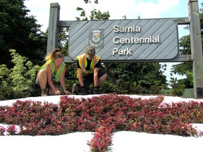 Kelsey Ferguson, left, and Connor Bezanson with the Sarnia Parks and Recreation Department work Tuesday June 13, 2017 on a garden at the Sarnia Centennal Park sign next to Front Street. An opening ceremony for the city park is planned for Saturday. (Paul Morden/Sarnia Observer)