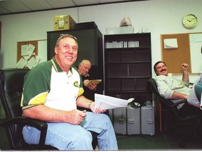 Eskimos coach Don Matthews, assisstant offensive coach Bill Macdermott and defensive line coach Greg Marshall get together in 1999 during a Canadian college draft conference call.