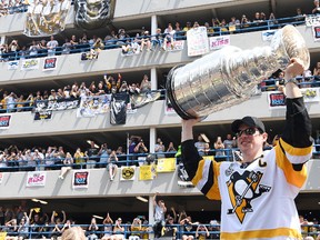 Sidney Crosby of the Pittsburgh Penguins hoists the Stanley Cup during the Victory Parade and Rally on June 14, 2017 in Pittsburgh. (Justin Berl/Getty Images)