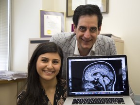 Sara Owanis holds an image of her brain in which Dr. David Steven placed electrodes to map epileptic activity at University Hospital in London. Owanis was one of the first people in Ontario to undergo the surgery using a new robot-assisted technique. (DEREK RUTTAN, The London Free Press)