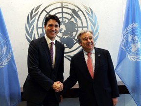 Canada's Prime Minister Justin Trudeau (L) shakes hands with United Nations Secretary General Antonio Guterres before a meeting at the UN headquarters in New York on April 6, 2017. (SAMADJEWEL SAMAD/AFP/Getty Images)