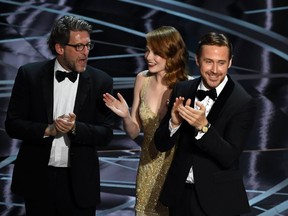 Producer Gary Gilbert, actors Emma Stone and Ryan Gosling celebrate 'La La Land' winning Best Picture due to a presentation error (the actual winner was later announced as 'Moonlight') onstage during the 89th Annual Academy Awards at Hollywood & Highland Center on February 26, 2017 in Hollywood, California. (Photo by Kevin Winter/Getty Images)