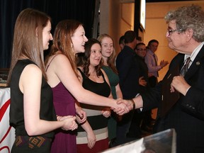 Chris Sheridan, founder of the Greater Sudbury Sports Hall of Fame and House of Kin congratulates the Krysta Burns rink for winning the team of the year at the 49th annual Greater Sudbury Sports Hall of Fame celebrity dinner and awards at the Caruso Club in Sudbury, Ont. on Wednesday June 14, 2017. From left are Krysta Burns, Sara Guy, Megan Smith and Laura Masters.Gino Donato/Sudbury Star/Postmedia Network