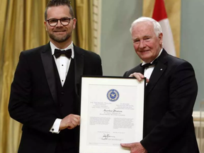 Citizen reporter Matthew Pearson receives the Michener-Deacon Fellowship from Gov. Gen. David Johnston during the Michener Awards at Rideau Hall on Wednesday, June 14, 2017.