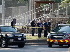 Law enforcement officers investigate the scene of a shooting near a baseball field in Alexandria, Va., Wednesday, June 14, 2017, where House Majority Whip Steve Scalise of La. was shot at a Congressional baseball practice. (AP Photo/Alex Brandon)