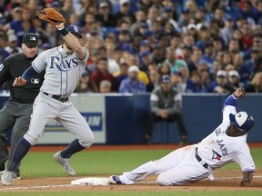 Jays outfield Dwight Smith Jr. slides into third base during Wednesday night's game against Tampa Bay. (GETTY IMAGES)