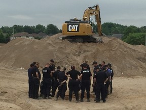 OPP officers on Thursday remained at the scene of a Komoka construction site where suspected human remains were found, forcing work to be halted. DEREK RUTTAN / THE LONDON FREE PRESS