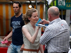 A passerby attacks Les Republicains party candidate Nathalie Kosciusko-Morizet while campaigning in Paris on June 15, 2017. (GEOFFROY VAN DER HASSELT/Getty Images)