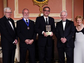 Russell Mills, left to right, president of the Michener Awards Foundation, London Free Press reporter Randy Richmond and Joe Ruscitti, editor in chief of the London Free Press, pose for a photo after receiving the Michener Award for Journalism from Governor General David Johnston as Sharon Johnston looks on at Rideau Hall, the official residence of the Governor General in Ottawa, Wednesday, June 14, 2017. (THE CANADIAN PRESS)