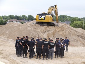 OPP officers were at a site near Parkview elementary school in Komoka Thursday, after a construction crew found unidentified remains. (DEREK RUTTAN, The London Free Press)