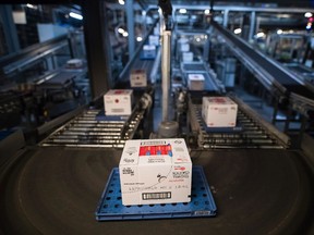 Products go by at the Sobeys Vaughan Retail Support Centre, equipped with robotics for automation in Vaughan, Ontario on Monday June 12, 2017. THE CANADIAN PRESS/Mark Blinch