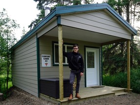 Reporter Scott Leitch outside one of the two new comfort camping cabins at Jubilee Park Campground beside Wizard Lake in Leduc County. (PHOTO BY LARRY WONG/POSTMEDIA)