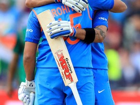 India’s Virat Kohli celebrates with Rohit Sharma (left) celebrate after defeating Bangladesh yesterday. (AP)