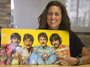 Cheryl Finn points to the OPP patch Paul McCartney is wearing on his sleeve on the gatefold of The Beatles? album Sgt. Pepper?s Lonely Hearts Club Band. Her grandfather, OPP Sgt. Randall Pepper, was head of the security detail for the Beatles when they visited Toronto in 1965. It is not clear who gave the OPP patch to McCartney. (DEREK RUTTAN, The London Free Press)