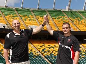 Canada's Aaron Carpenter (right), of Brantford, Ont., will break the record for games played during a test match on Saturday versus Romania poses with Al Charron of Ottawa after practice at Commonwealth Stadium in Edmonton on June 15, 2017.