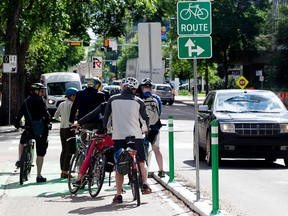 Cyclists ride along 100 Avenue near 108 Street during a preview of the first leg of the City's downtown bike grid, in Edmonton Thursday June 15, 2017. Photo by David Bloom