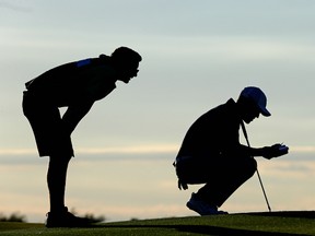 Cameron Champ of the United States and caddie Jake Goodman line up a putt on the eighth green during the first round of the U.S. Open at Erin Hills on June 15, 2017. (Jamie Squire/Getty Images)