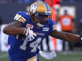Bombers wide receiver T.J. Thorpe straightens his arm to fend off an Edmonton Eskimos tackler during a CFL preseason game. (Kevin King/Postmedia Network)