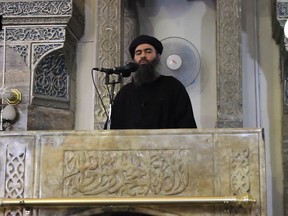 This image grab taken from a propaganda video released on July 5, 2014 by al-Furqan Media allegedly shows the leader of the Islamic State (IS) jihadist group, Abu Bakr al-Baghdadi, aka Caliph Ibrahim, adressing Muslim worshippers at a mosque in the militant-held northern Iraqi city of Mosul.