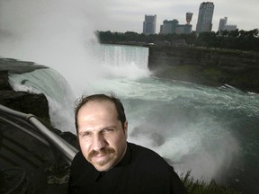 In this Aug. 13, 2004, file photo, Kirk Jones poses for a photo at Terrapin Point on the American side of Horseshoe Falls in Niagara Falls State Park, N.Y. Jones, who survived a plunge over Niagara Falls without protection in 2003 has died after he went over again, this time inside an inflatable ball. Police told the Syracuse Post-Standard that the body of the 53-year-old was found in the Niagara River by the U.S. Coast Guard on June 2, 2017.