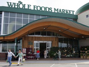 In this May 9, 2007 file photo, customers are seen outside a Whole Foods Market in Dallas. Online juggernaut Amazon announced Friday, June 16, 2017, that it is buying Whole Foods in a deal valued at about $13.7 billion, including debt. Amazon.com Inc. will pay $42 per share of Whole Foods Market Inc. AP Photo/LM Otero, file)