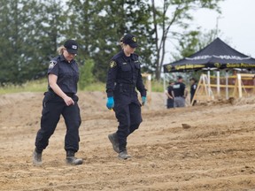 Several police were searching a new home construction site in Komoka, Ontario on Thursday, June 15, 2017 after workers discovered remains Wednesday. Police later confirmed the remains were human and historic in nature. Derek Ruttan/The London Free Press/Postmedia Network