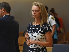In this Monday, June 12, 2017 file photo, Michelle Carter stands as court is in recess at the end of the day at her trial in Taunton, Mass. Carter is charged with involuntary manslaughter for encouraging Conrad Roy III to kill himself in July 2014. The judge is set to issue a verdict in the case on Friday. (Faith Ninivaggi/The Boston Herald via AP, Pool, File)