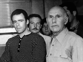 In this May 18, 1971 file photo, Joseph Sullivan, left, is escorted by John J. McCarthy, with the Department of Corrections, after being apprehended on a Greenwich Village street in New York. (AP Photo/Robert Willett, File)