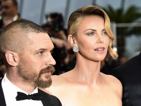 South African-US actress Charlize Theron (R) and US actor Tom Hardy pose as they arrive for the screening of the film 'Mad Max : Fury Road' during the 68th Cannes Film Festival in Cannes, southeastern France, on May 14, 2015. (LOIC VENANCE/AFP/Getty Images)