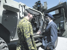 Minister of National Defence Minister Harjit Sajjan speaks with Cpl.Kevin Huard following the announcement of the Canadian Defence Review in Ottawa, Wednesday, June 7, 2017. (THE CANADIAN PRESS/Adrian Wyld)