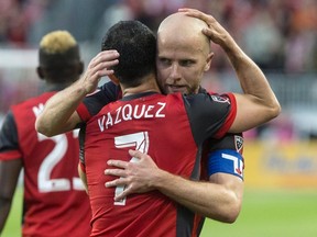 Toronto FC captain Michael Bradley congratulates Victor Vazquez for scoring against the Columbus Crew during MLS action in Toronto on May 26, 2017. (THE CANADIAN PRESS/Chris Young)