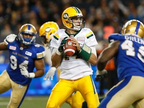 Edmonton Eskimos' quarterback Zach Kline (14) throws against the Winnipeg Blue Bombers during the second half of CFL action in Winnipeg Thursday, June 15, 2017.