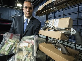 Toronto Police Insp. Peter Moreira, who heads up the Integrated Gun & Gang Task Force, speaks about Project Kronic with guns and money siezed in this week's raids on Friday June 16, 2017. (Craig Robertson/Toronto Sun)
