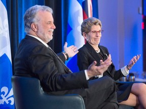 Ontario Premier Kathleen Wynne, right, and Quebec Premier Philippe Couillard speak to a business luncheon in Montreal on Thursday, December 15, 2016. THE CANADIAN PRESS/Ryan Remiorz