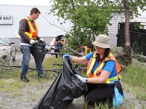 Graham Tushingham, left, of Cambrian College, and Lise Timony, of College Boreal, participate in a community clean-up around Sudbury, Ont. on Friday June 16, 2017. More than 100 employees from Cambrian College and College Boreal participated in the collaborative effort. John Lappa/Sudbury Star/Postmedia Network