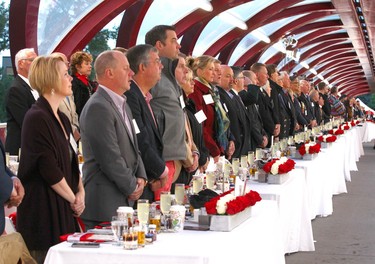 Guests sing the national anthem during the third annual Breakfast on the Bridge event  on Saturday June 17, 2017 in Calgary. The event takes place every two years, at sunrise, rain or shine, on the Peace Bridge and raises funds and awareness for the Calgary Military Family Resource Centre. Jim Wells//Postmedia