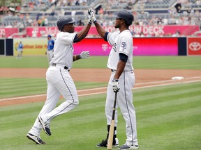 Jose Pirela (left) is greeted by Franchy Cordero after socking a homer for the Padres against the Royals earlier this month. (Gregory Bull, AP)