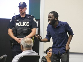 Desmond Cole interrupts the Toronto Police Services Board meeting along with members of Black Lives Matter at the on Thursday June 15, 2017. (Veronica Henri/Toronto Sun)